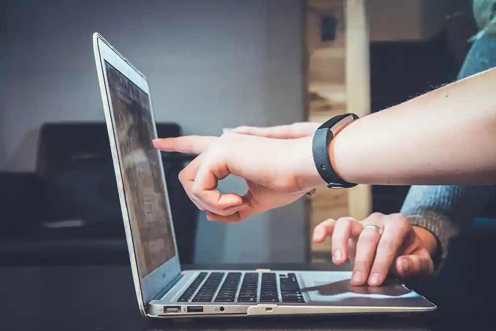 Hands working on a laptop
